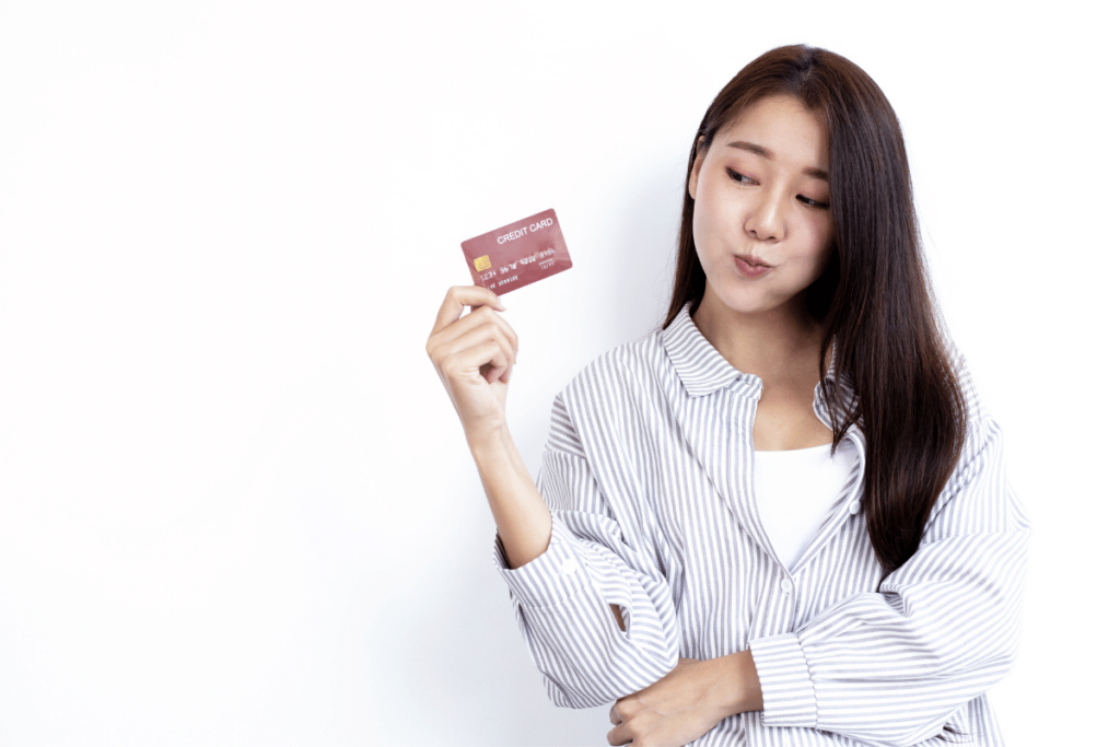 Woman Holding Credit Card To Add Authorized User